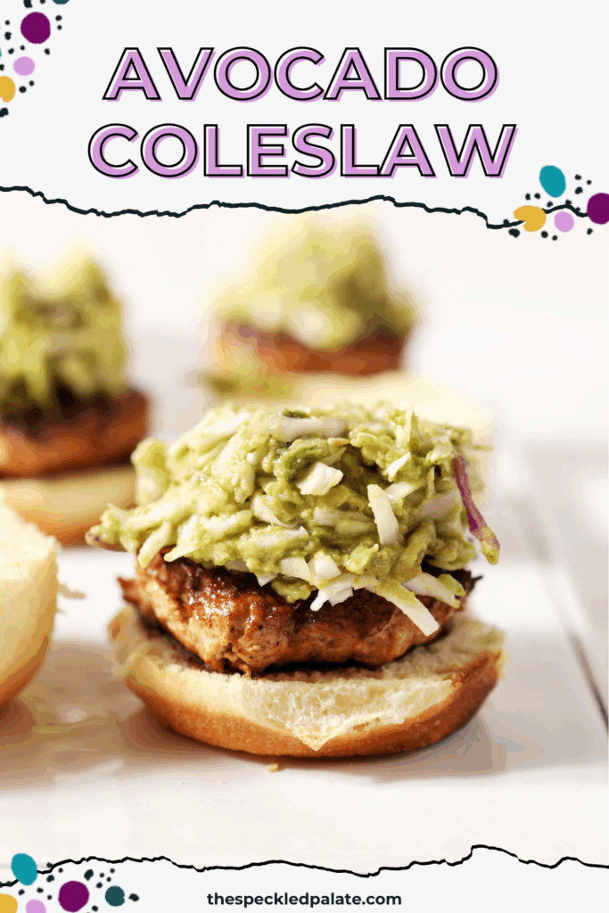 Avocado coleslaw on top of a bbq chicken burger on a white platter with the text avocado coleslaw
