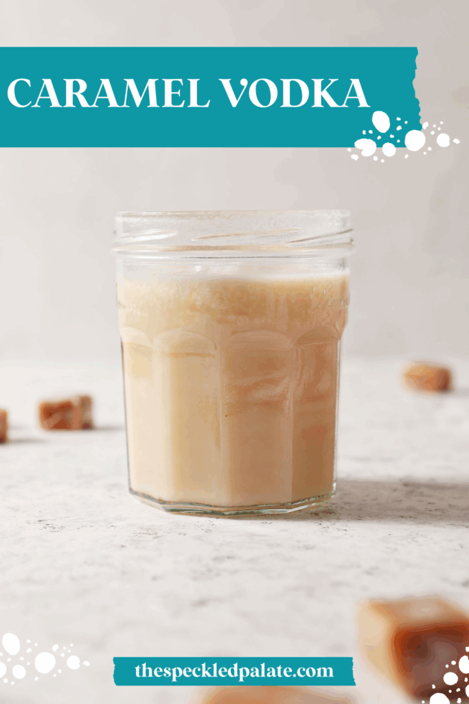infused caramel vodka in a jar on a white stone surface surrounded by candy caramels with the text caramel vodka