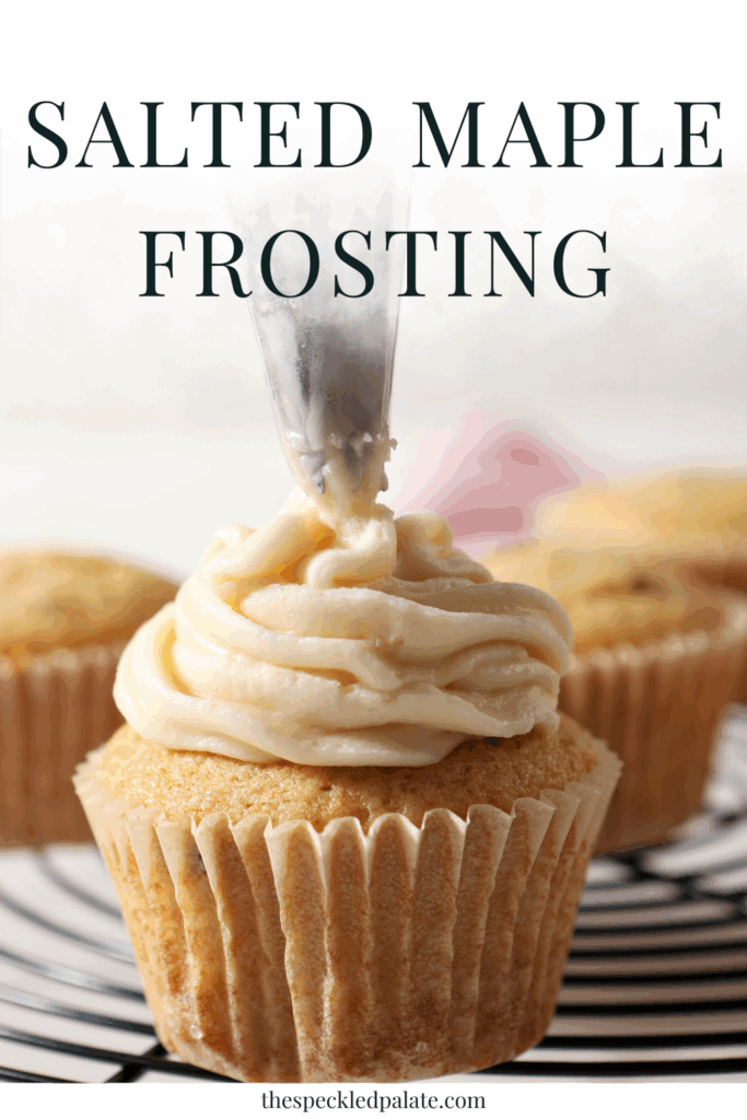 A cupcake is frosted with Salted Maple Frosting in a frosting bag on a cooling rack with the text salted maple frosting
