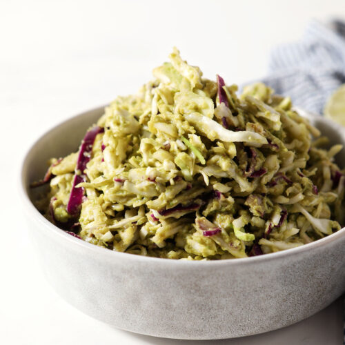Side angle of homemade avocado coleslaw in a bowl