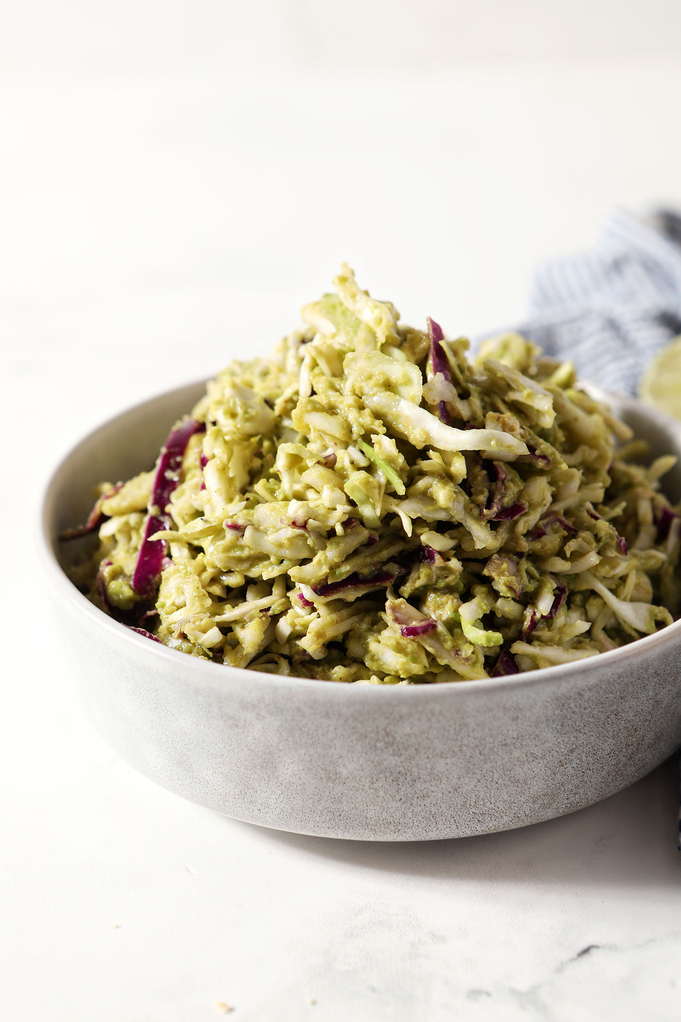 Side angle of homemade avocado coleslaw in a bowl