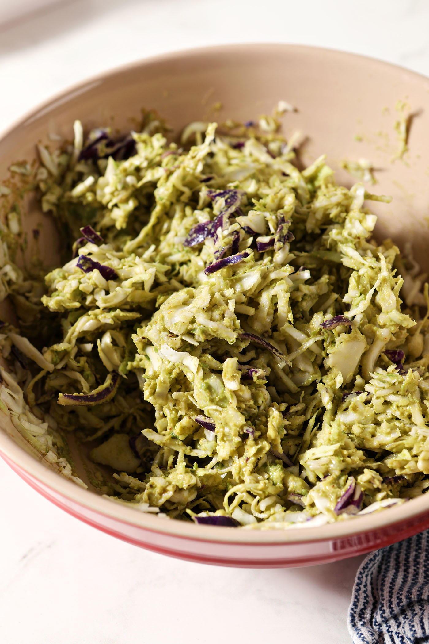Avocado coleslaw in a bowl after mixing
