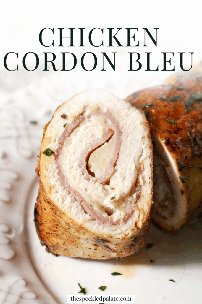Close up of a sliced piece of chicken cordon bleu on a white plate with the text chicken cordon bleu