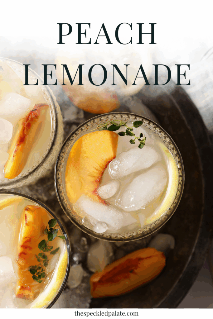 Overhead of three glasses of peach lemonade in a metal bowl with ice on a white tiled surface with a blue striped linen with the text peach lemonade