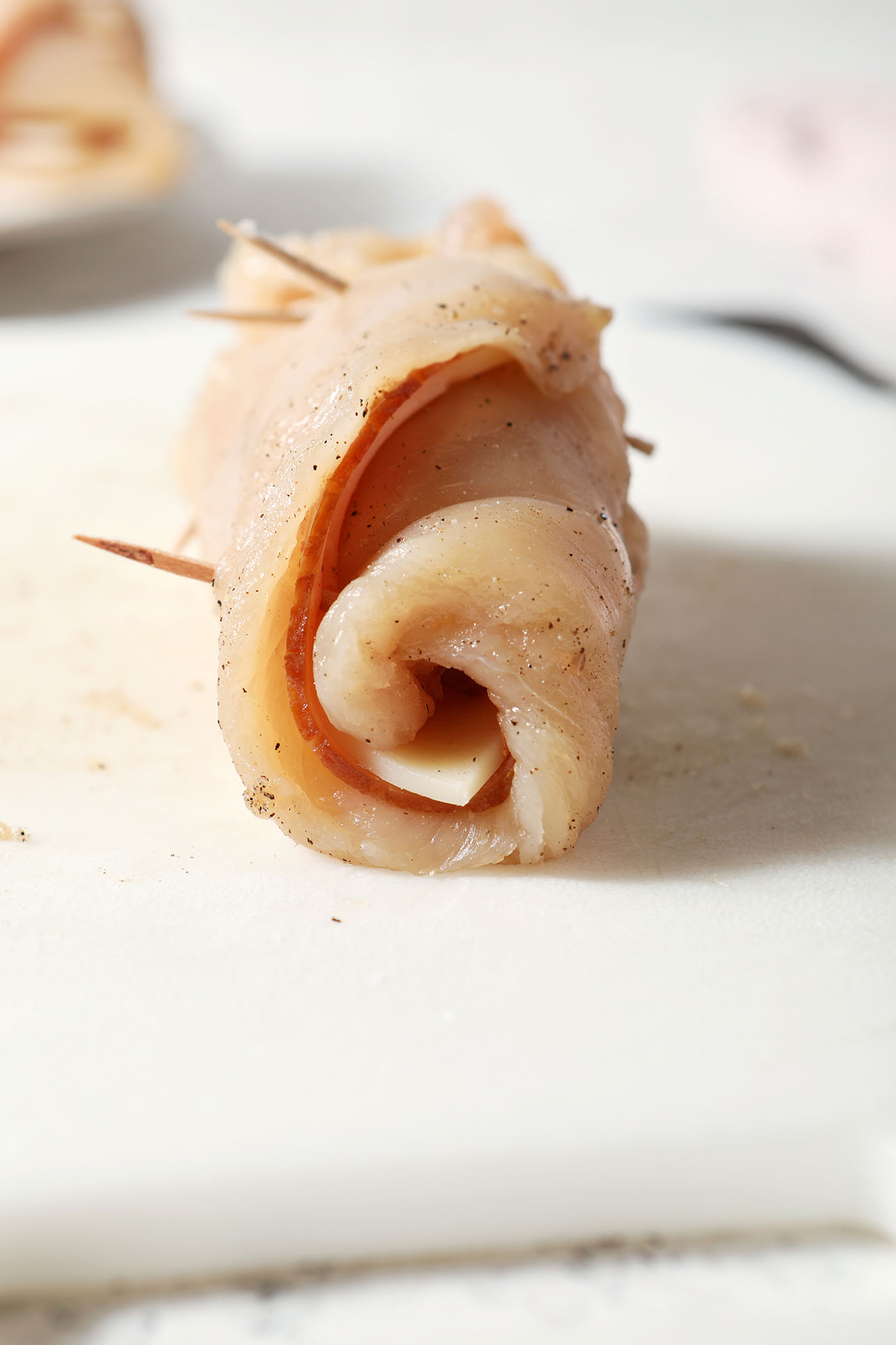 Chicken cordon bleu after rolling on a cutting board