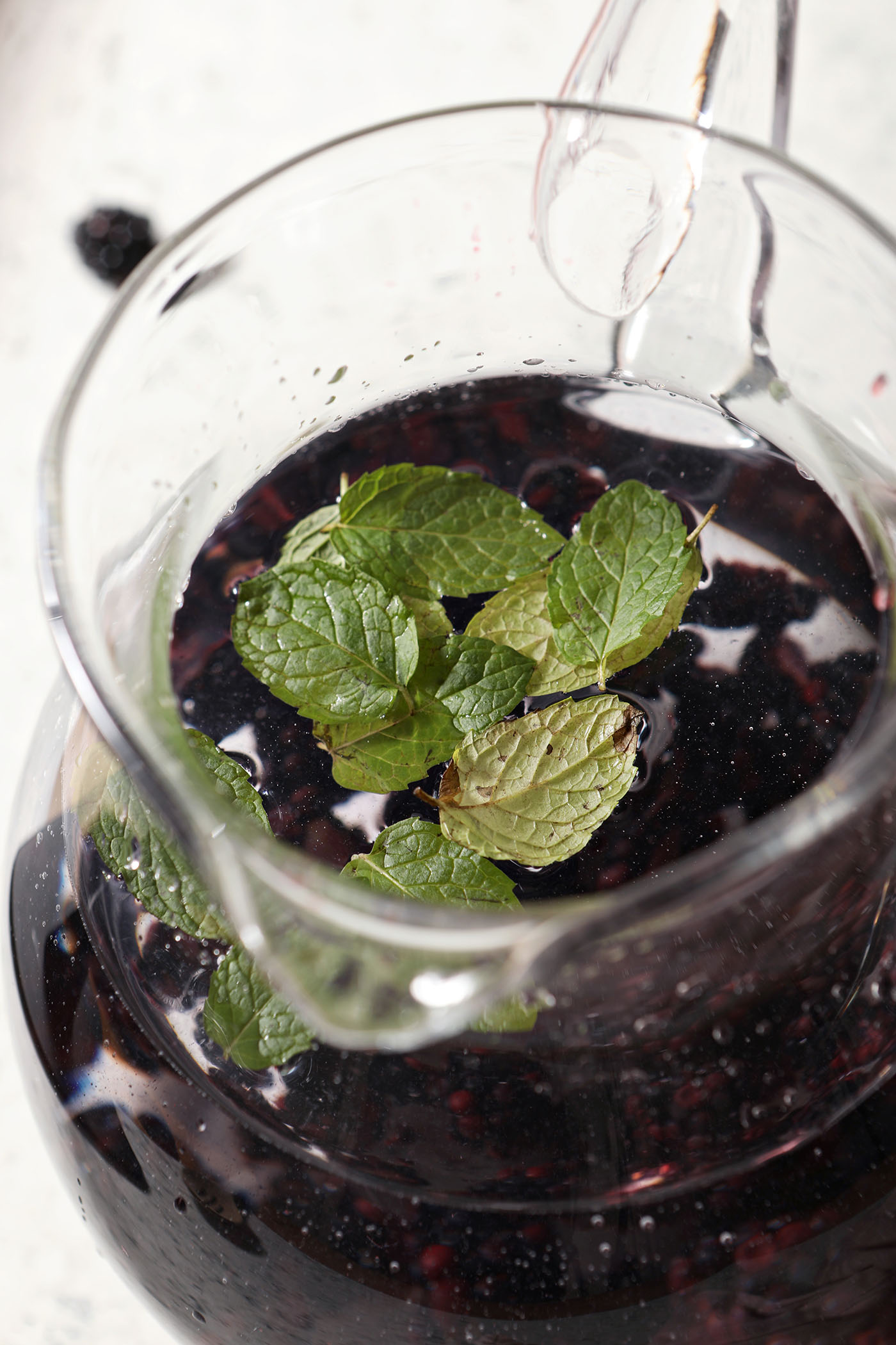 Close up of mint leaves floating on top of spa water