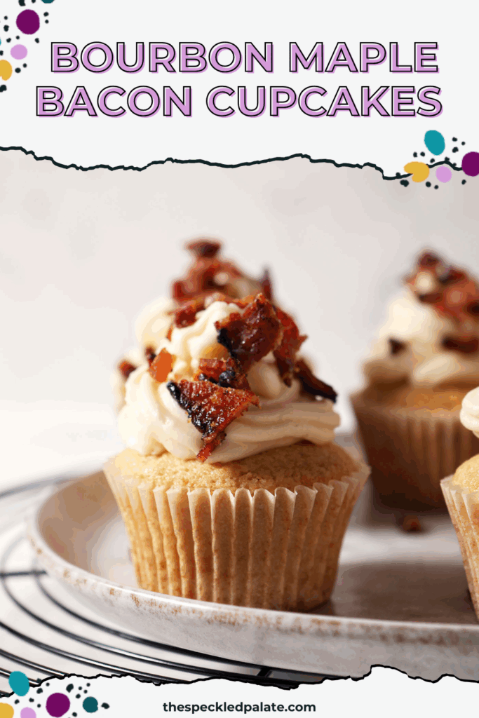 Decorated Maple Bacon Cupcakes on a grey plate on top of a wire cooling rack with the text bourbon maple bacon cupcakes