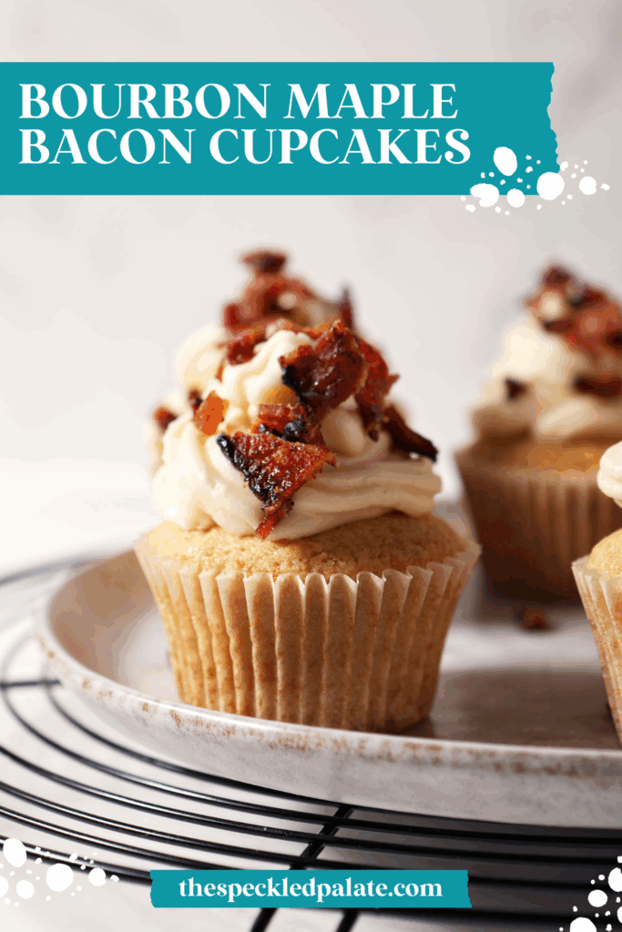 Decorated Maple Bacon Cupcakes on a grey plate on top of a wire cooling rack with the text bourbon maple bacon cupcakes