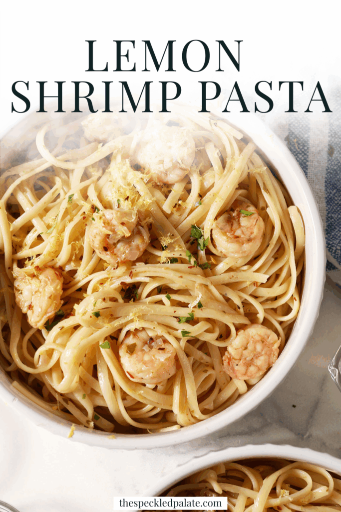 Close up of a bowl of lemon shrimp pasta garnished with extra parsley, lemon zest and red pepper flakes with the text lemon shrimp pasta