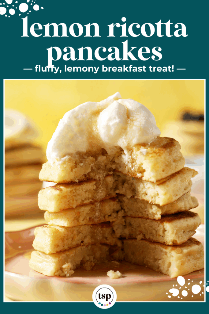 A cut into stack of pancakes topped with whipped cream and maple syrup on a pink plate on a yellow surface with the text lemon ricotta pancakes fluffy, lemony breakfast treat!