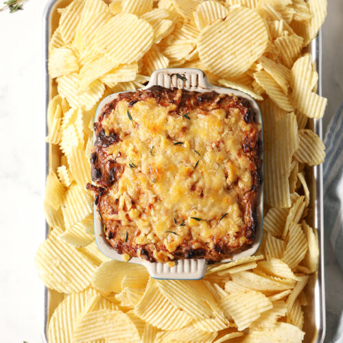 Overhead of Hot Caramelized Onion Dip after coming out of the oven surrounded by ruffled potato chips