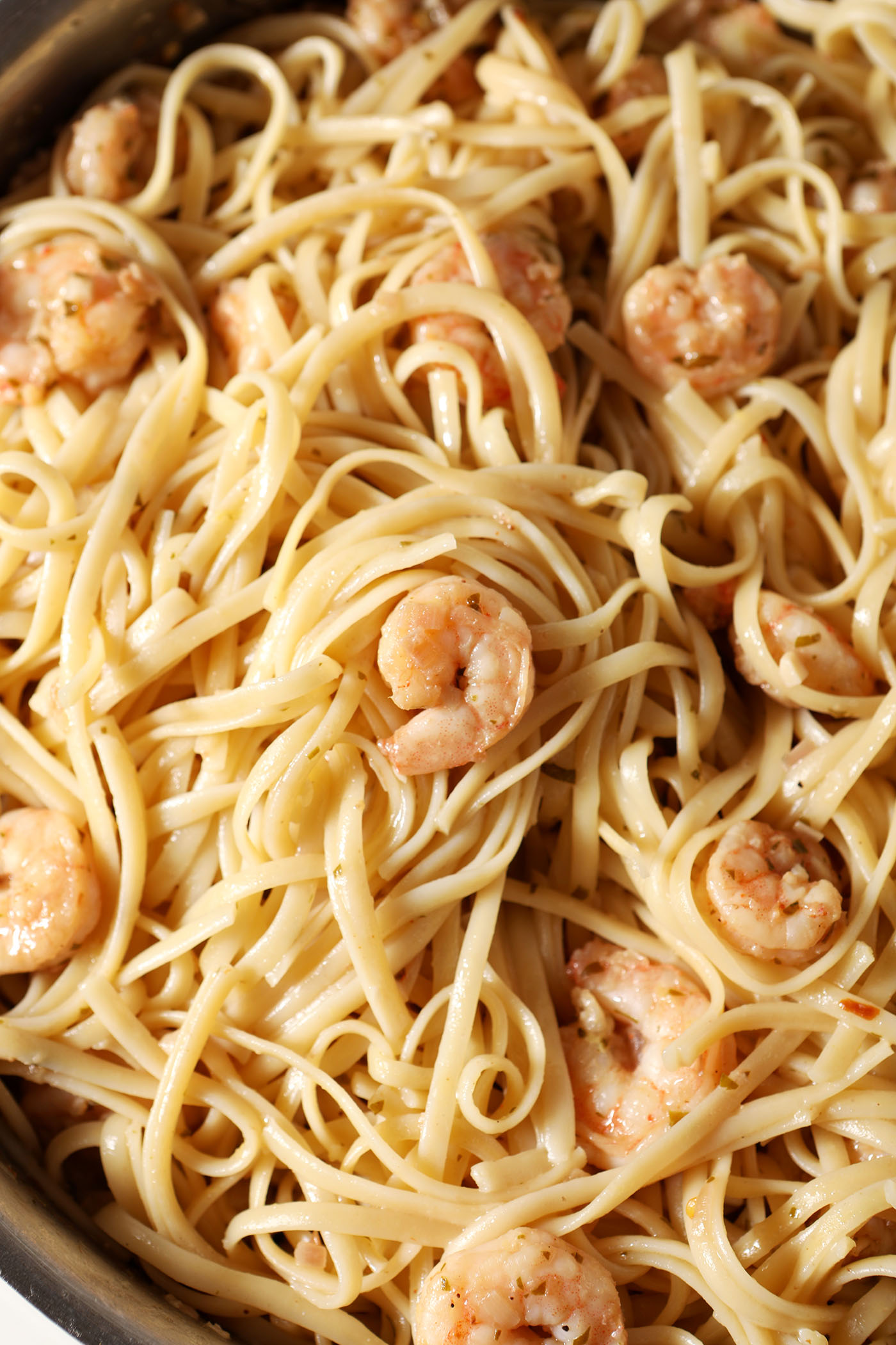 The final lemon shrimp pasta in the skillet after tossing together