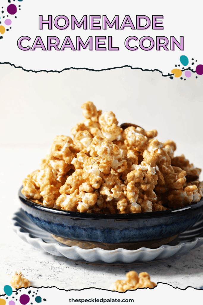A blue bowl is heaped high with caramel corn on a stone surface, surrounded by caramel corn bits with the text homemade caramel corn