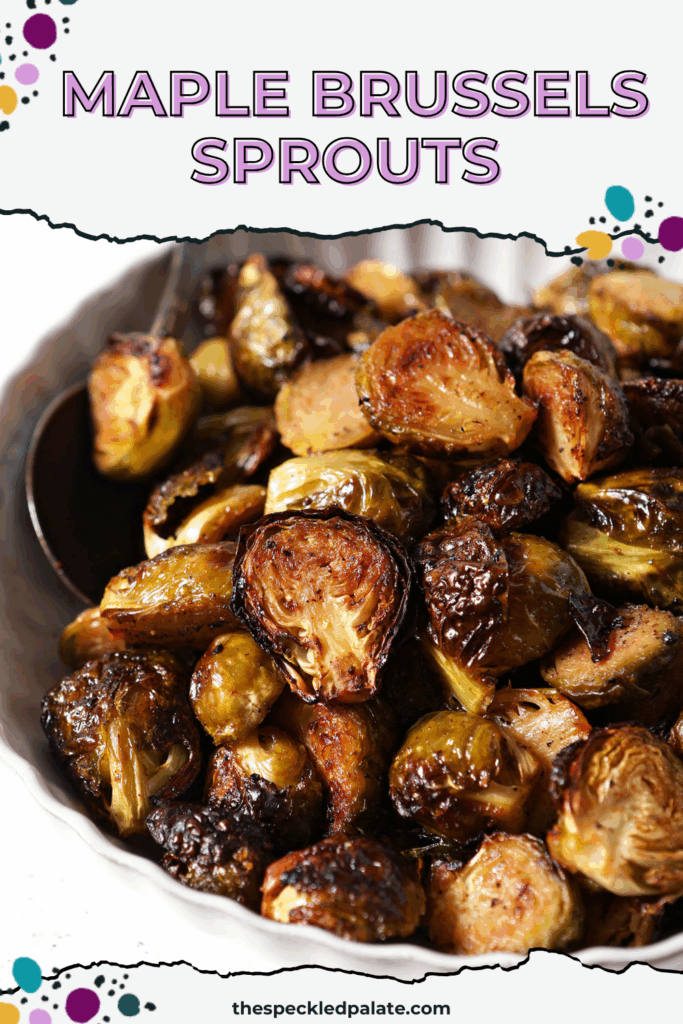 A bowl of Roasted Brussels Sprouts on a white surface with a spoon in it with the text maple brussels sprouts