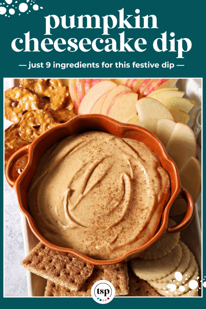 Close up of a pumpkin-shaped bowl holding Pumpkin Cheesecake Dip, surrounded by crackers and apple slices with the text pumpkin cheesecake dip just 9 ingredients for this festive dip
