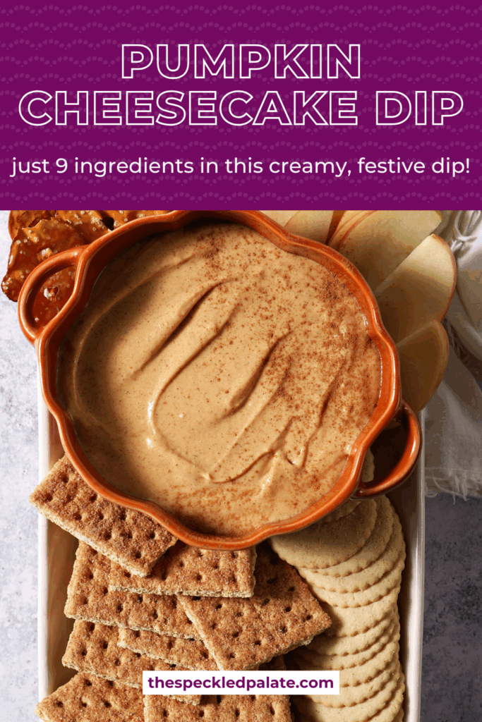 Close up of a pumpkin-shaped bowl holding Pumpkin Cheesecake Dip, surrounded by crackers and apple slices with the text pumpkin cheesecake dip just 9 ingredients for this creamy, festive dip