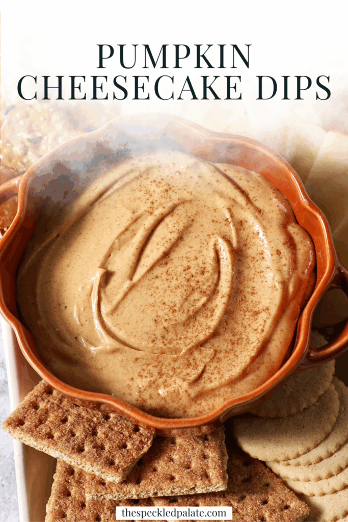 Close up of a pumpkin-shaped bowl holding Pumpkin Cheesecake Dip, surrounded by crackers and apple slices with the text pumpkin cheesecake dip