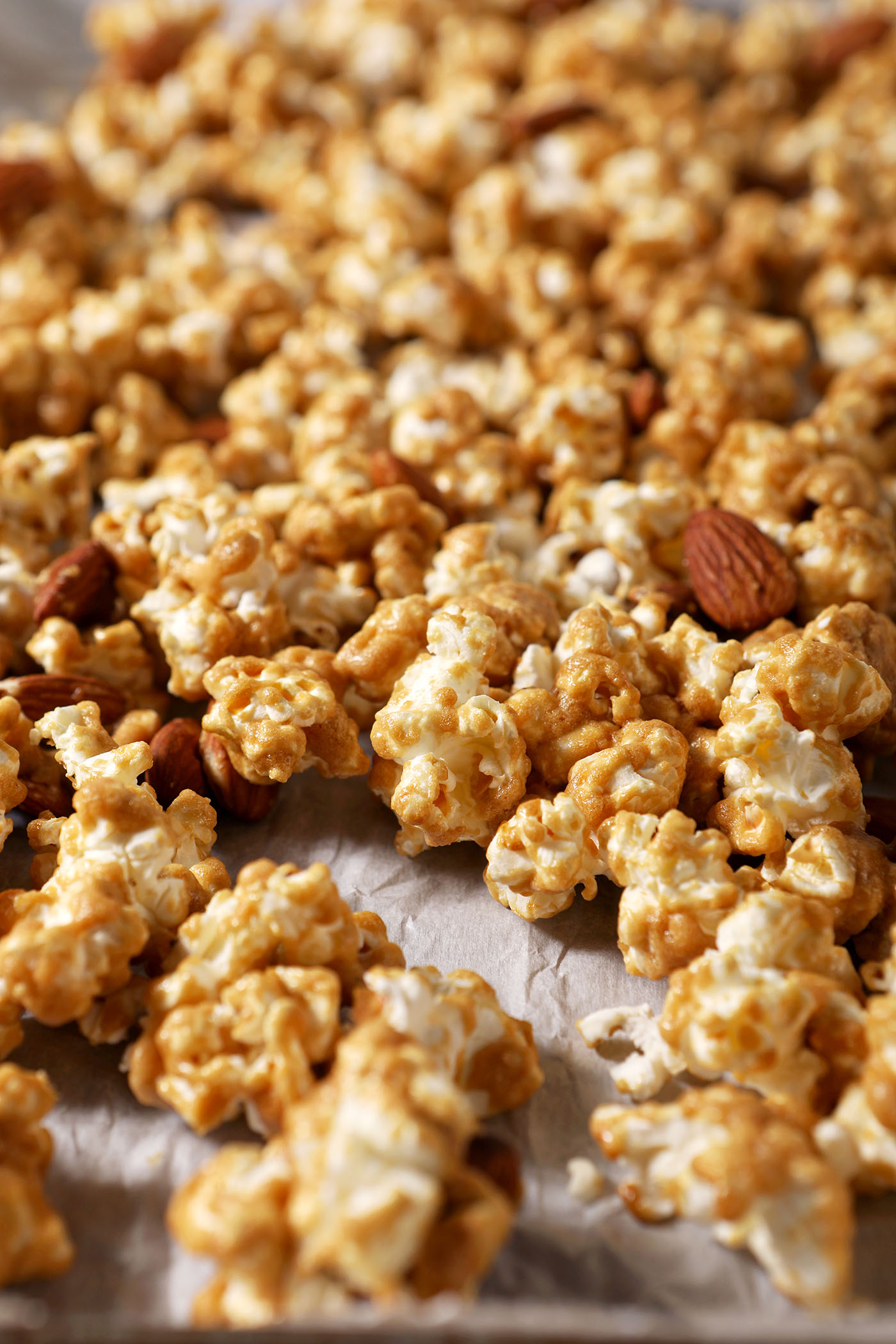Caramel corn with almonds on a sheet pan after baking