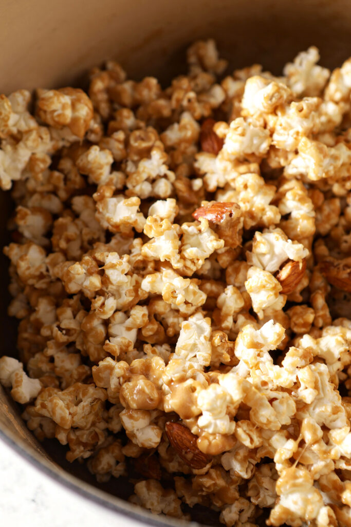 Coated caramel corn and almonds in a pot