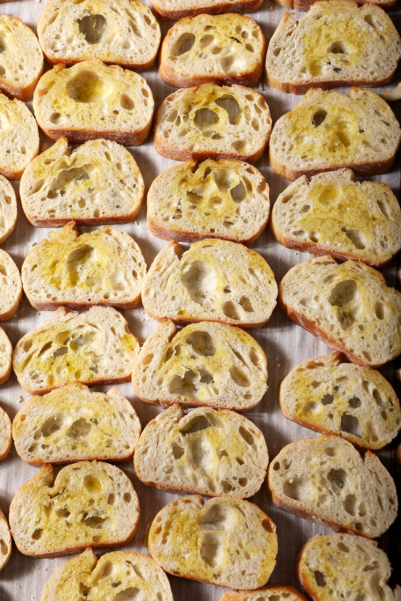 Crostini on a sheet pan, before baking
