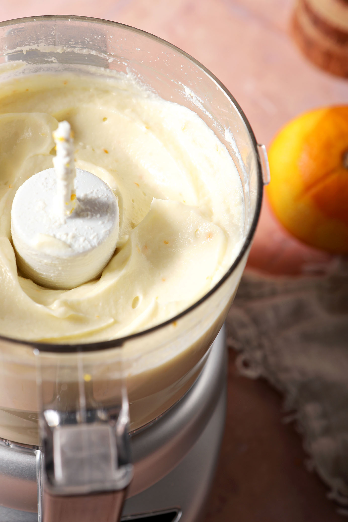 Whipped ricotta in a food processor, after blending and before adding the herbs