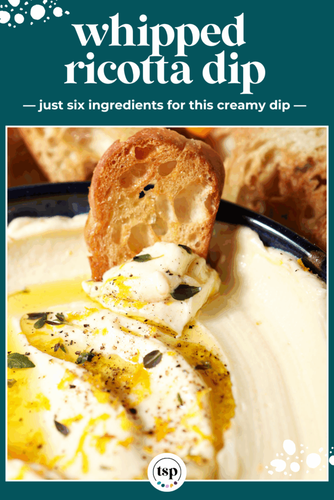 A crostini sits on top of a bowl of whipped ricotta garnished with oil, herbs and orange zest with the text whipped ricotta dip just six ingredients for this creamy dip