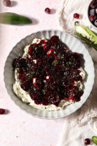 Overhead of a bowl holding Cranberry Cream Cheese Dip garnished with chopped parsley