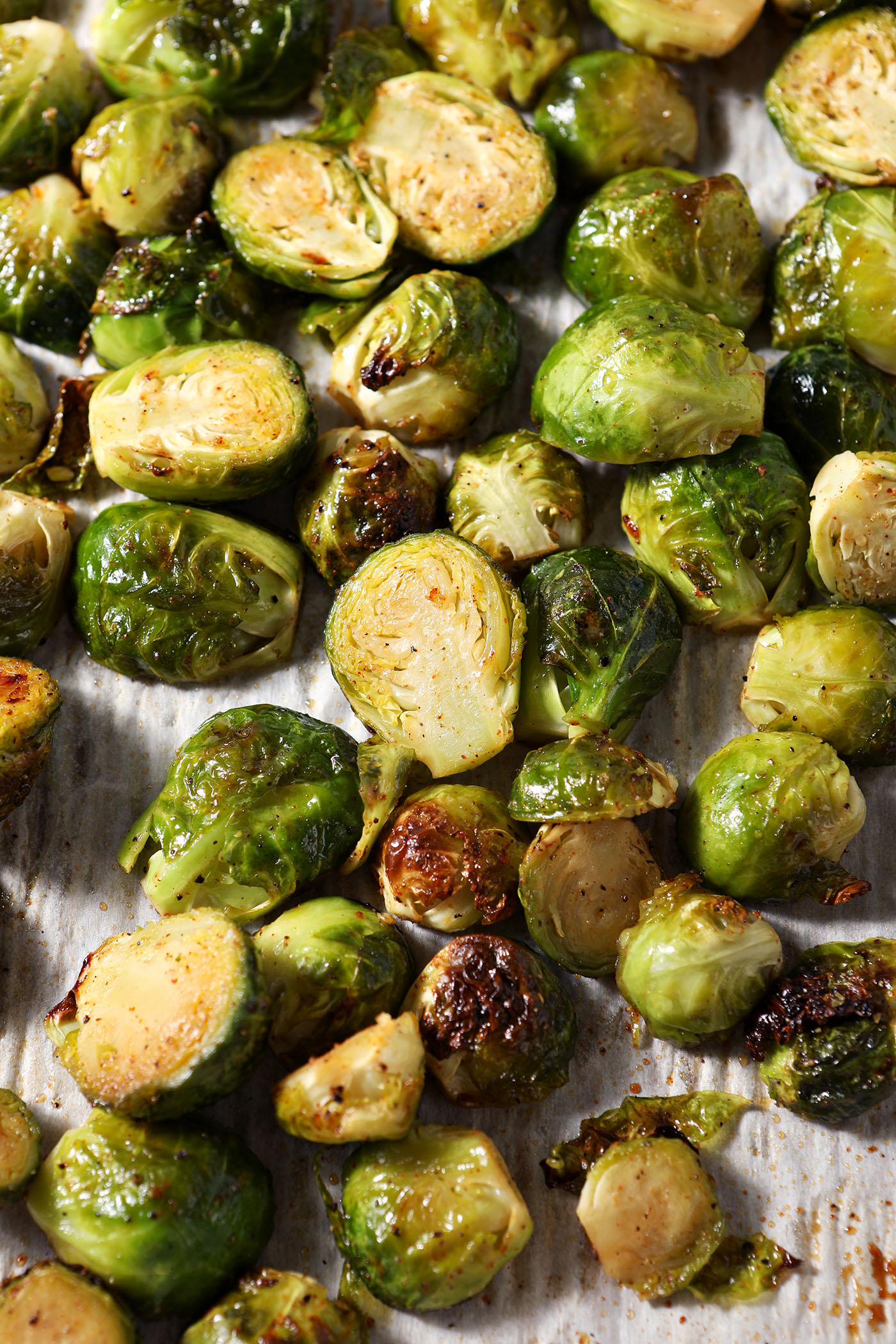 Brussels sprouts on a sheet pan, halfway through roasting