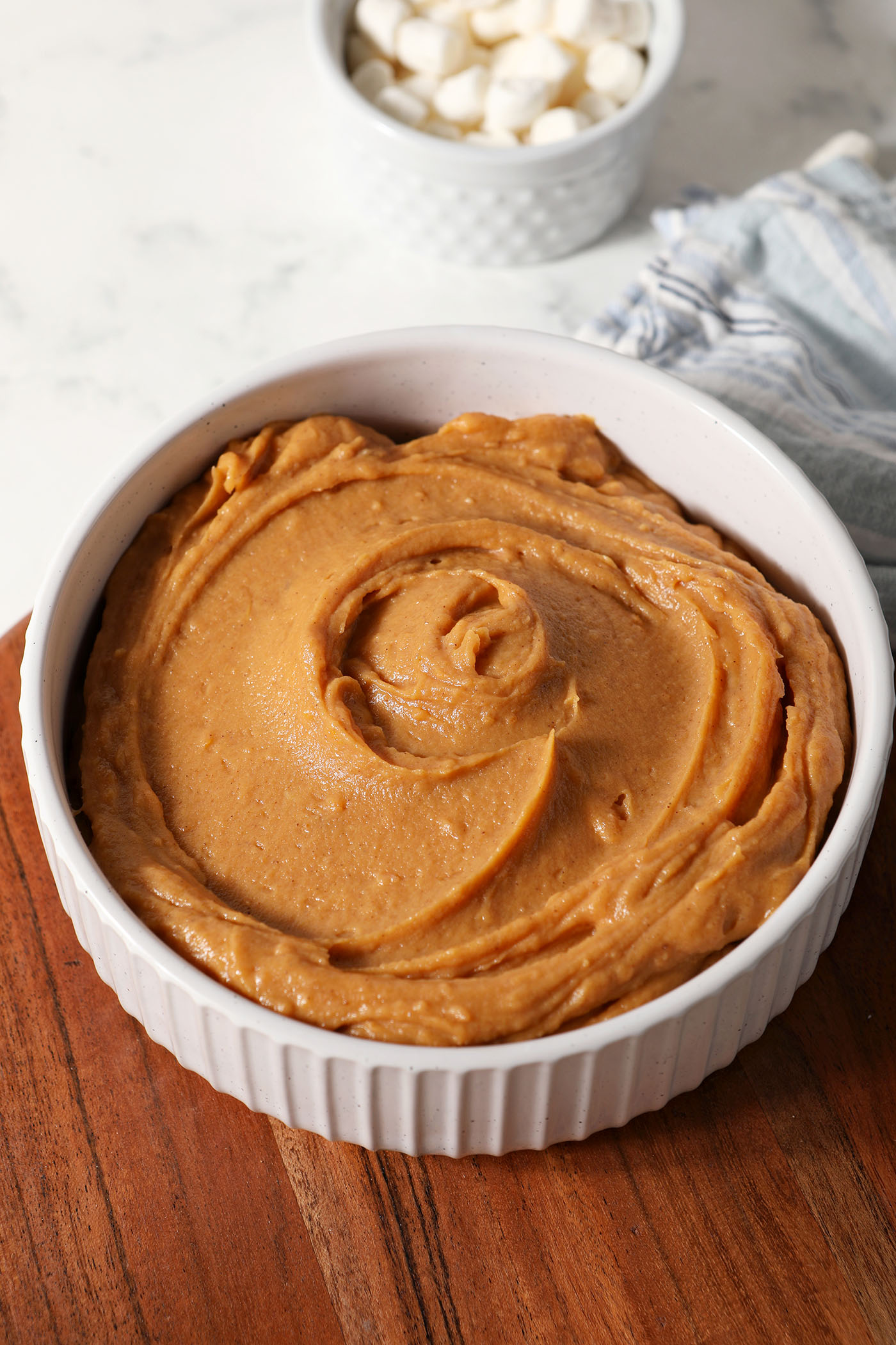 Sweet Potato Pie Dip in a serving bowl on a wooden surface before garnishing and serving