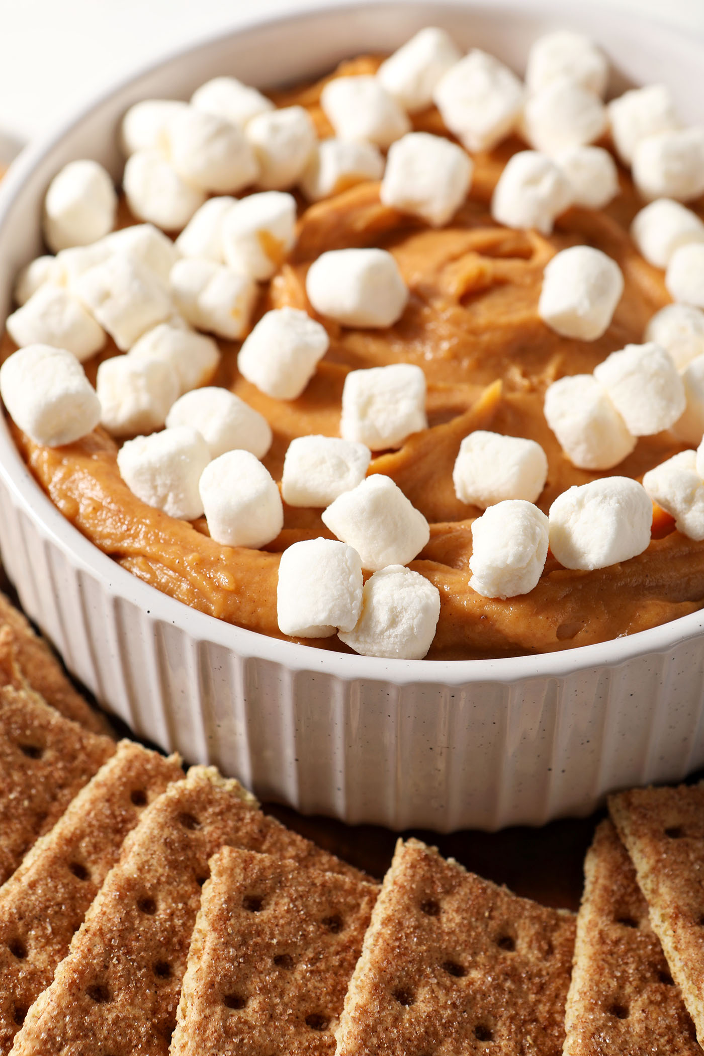 Mini marshmallows sit on top of sweet potato dessert dip