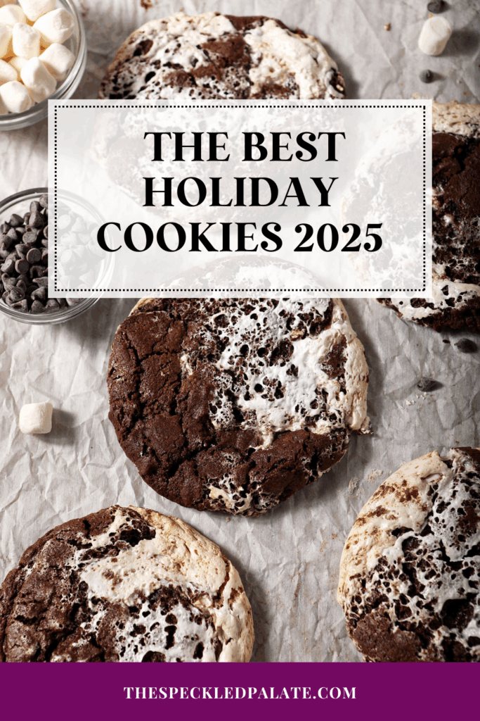 overhead of hot cocoa cookies stacked on a parchment-lined sheet pan with the text the best holiday cookies 2025