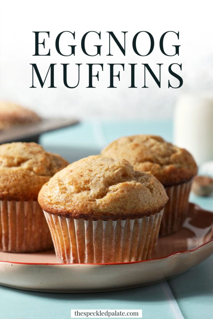 A plate of muffins on a green tiled surface in front of a muffin tin with the text eggnog muffins