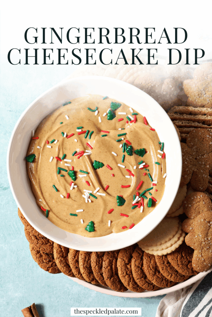 Overhead of a bowl of gingerbread dip next to cookies and crackers on a teal surface with the text gingerbread cheesecake dip
