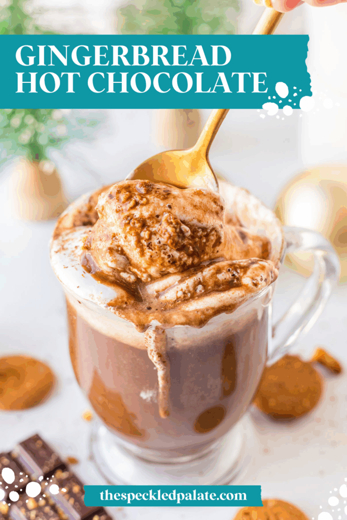 A spoon stirs marshmallow fluff into a mug of hot cocoa with the text gingerbread hot chocolate