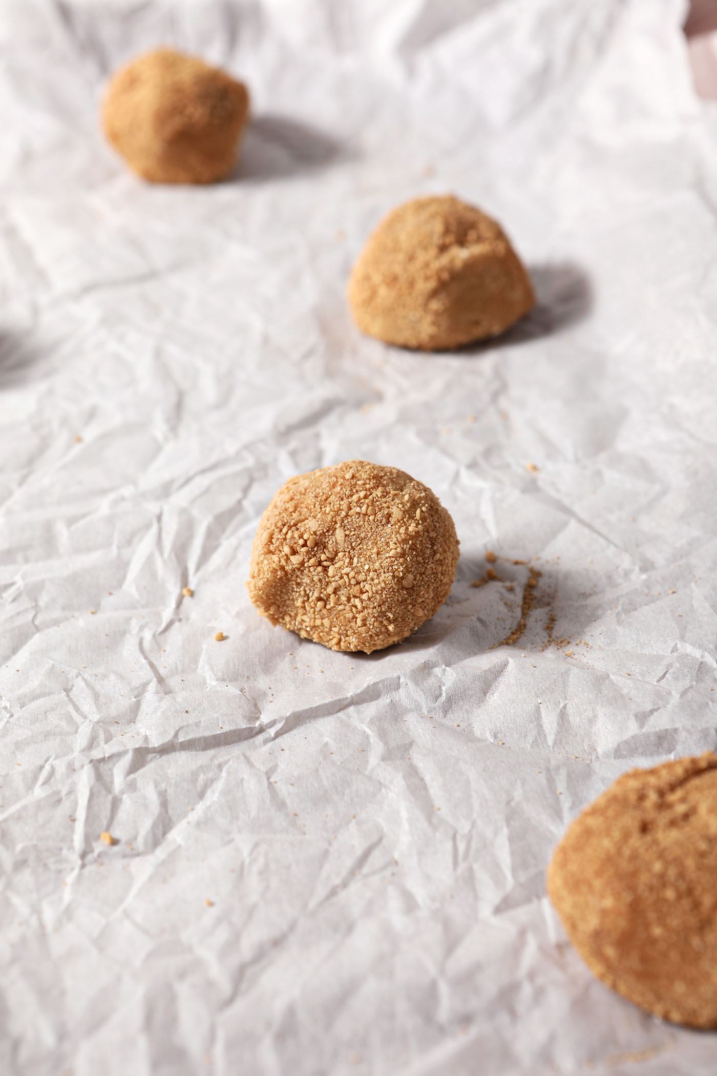 Spiced maple cookies on a sheet pan lined with parchment paper before baking