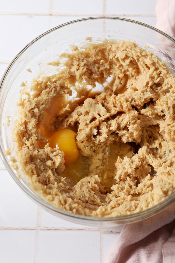 An egg, vanilla extract and maple extract in a bowl before blending