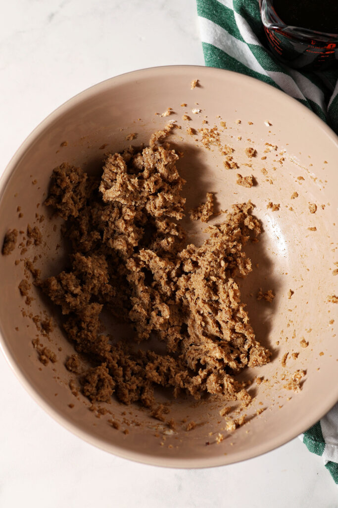 Brown sugar mixed with butter and ginger in a bowl