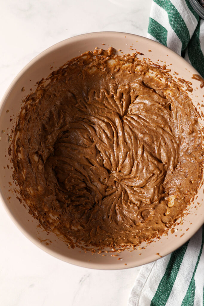Wet ingredients for chocolate ginger cookies in a bowl after mixing