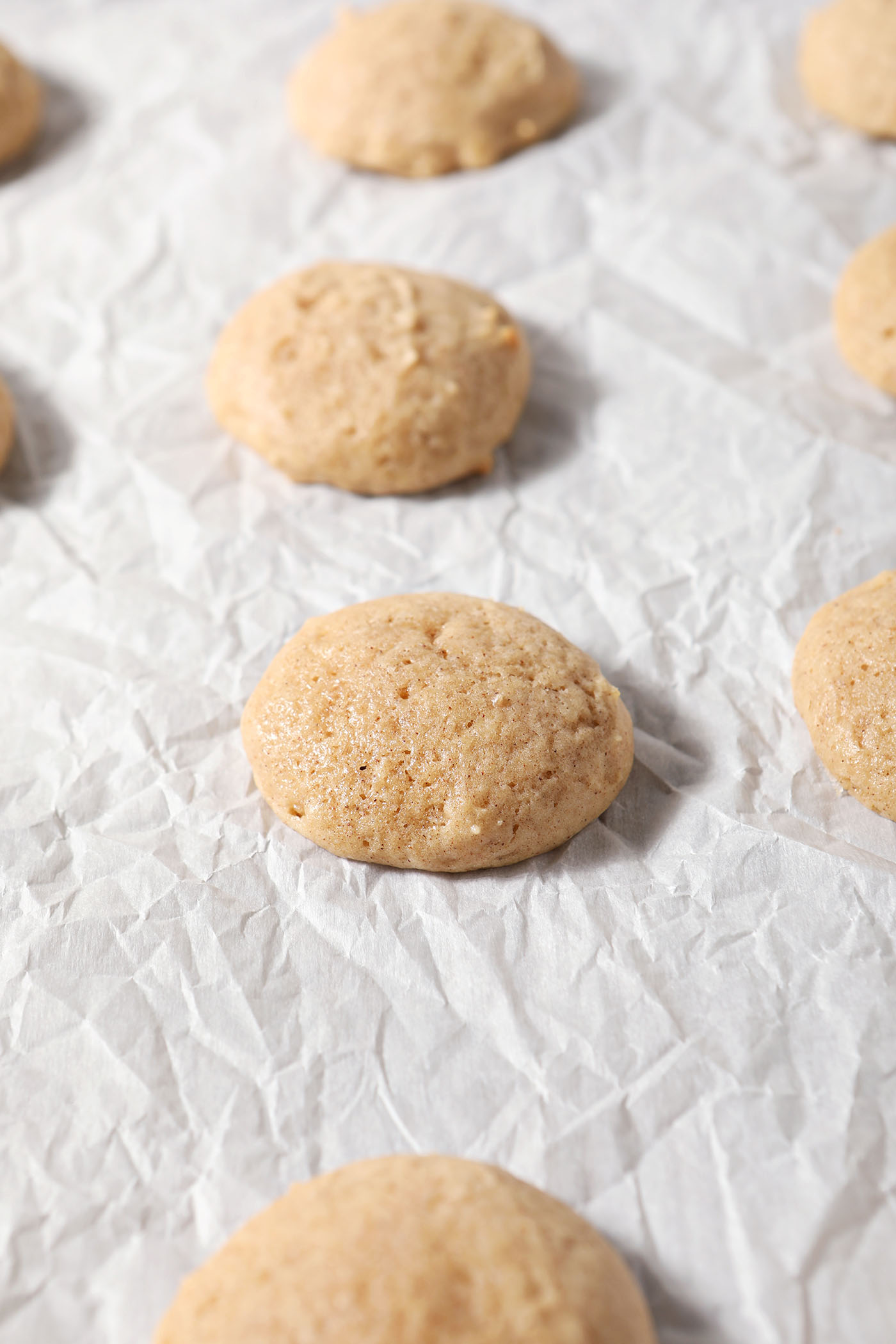 Baked eggnog cookies on parchment after baking
