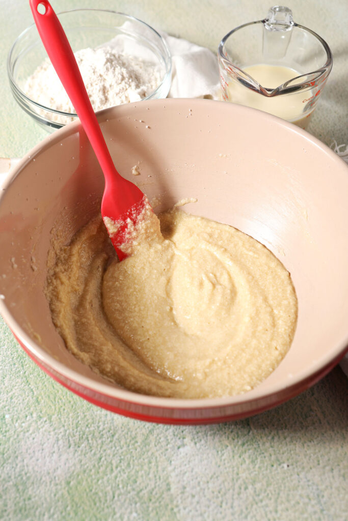 Wet ingredients in a bowl with a rubber spatula