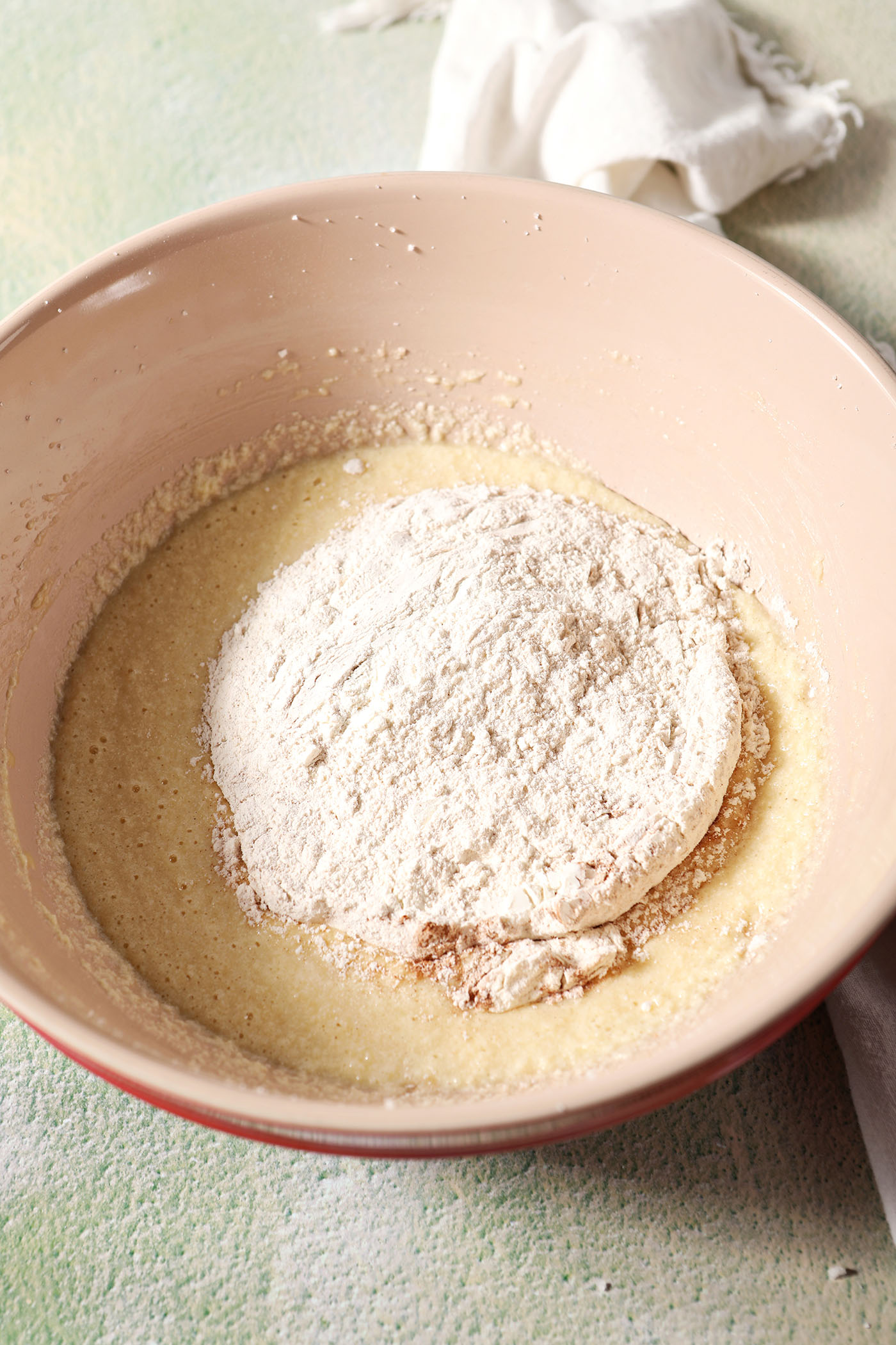 Dry ingredients on top of wet ingredients in a bowl