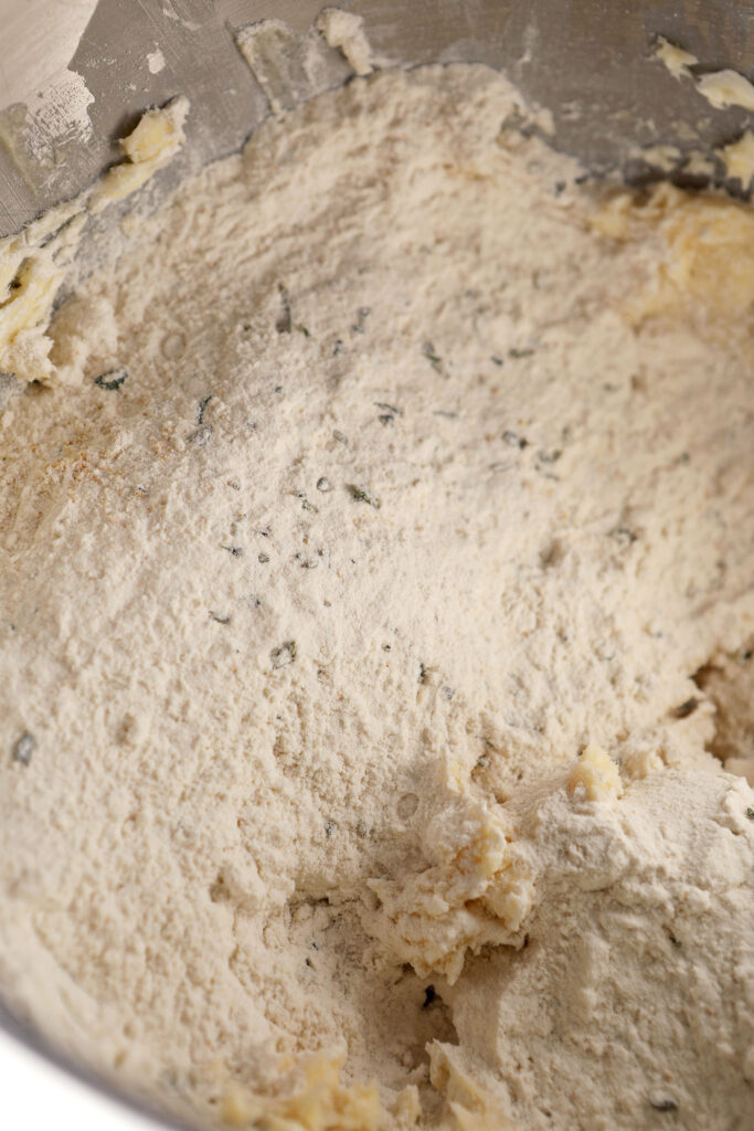Dry ingredients on top of creamed butter mixture in a metal mixing bowl
