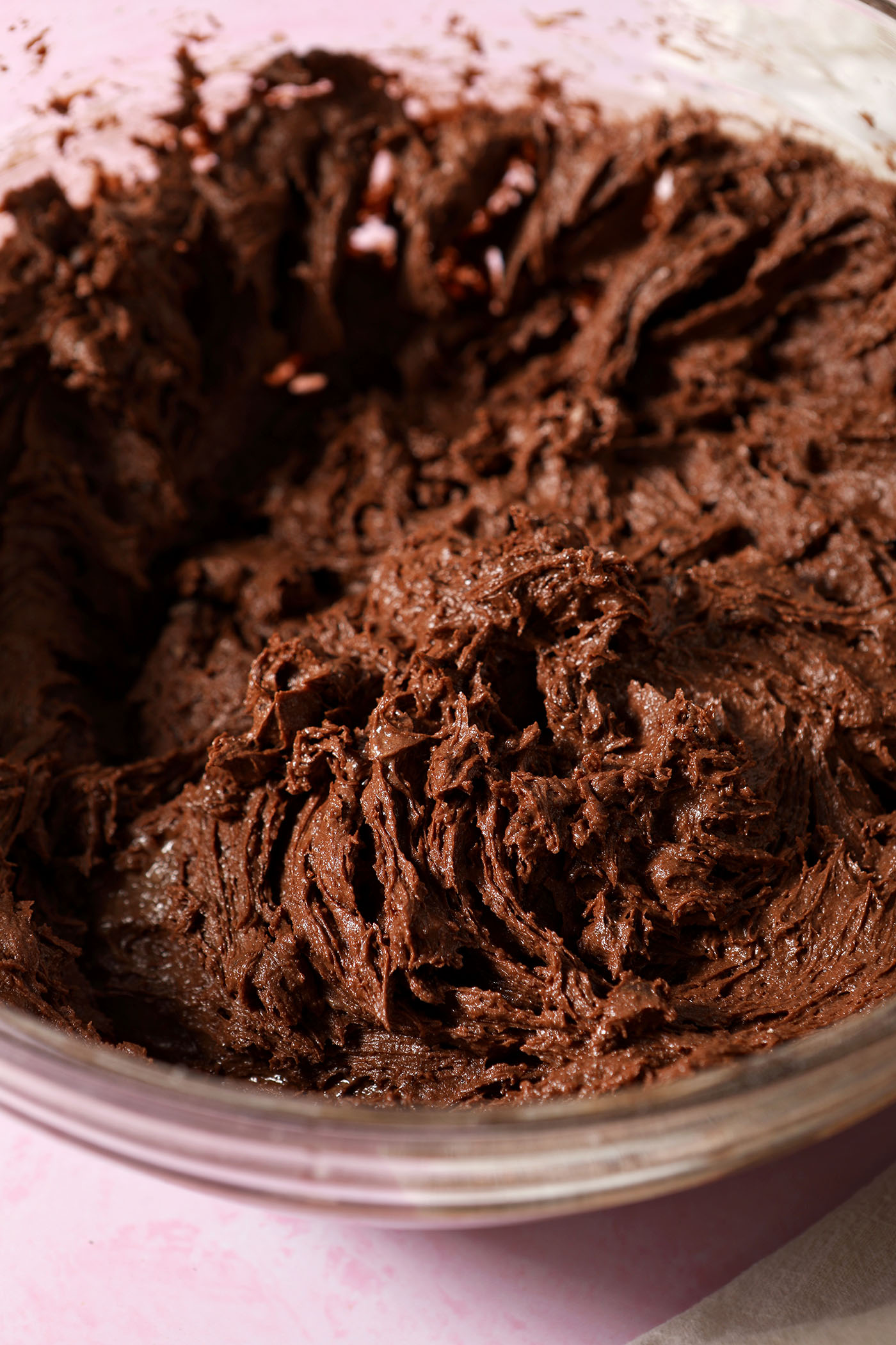 Hot cocoa cookie dough in a bowl on a pink surface