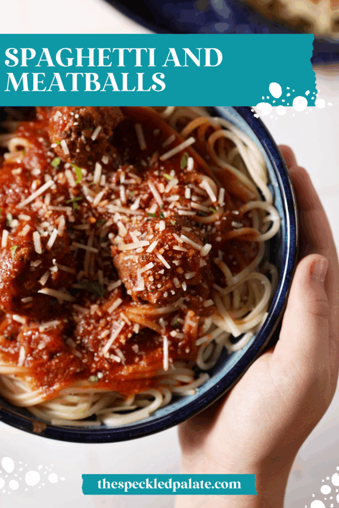 A person holds a blue bowl of spaghetti and meatballs, garnished with parsley and parmesan cheese with the text spagehtti and meatballs