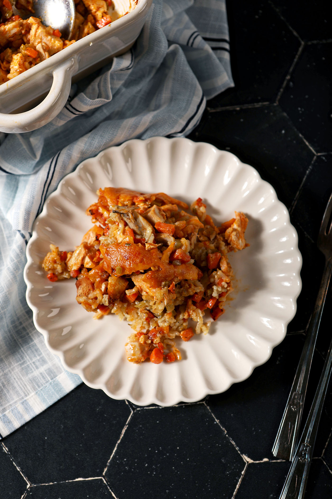 Overheard of a serving of Buffalo Chicken Casserole on a plate next to a casserole dish
