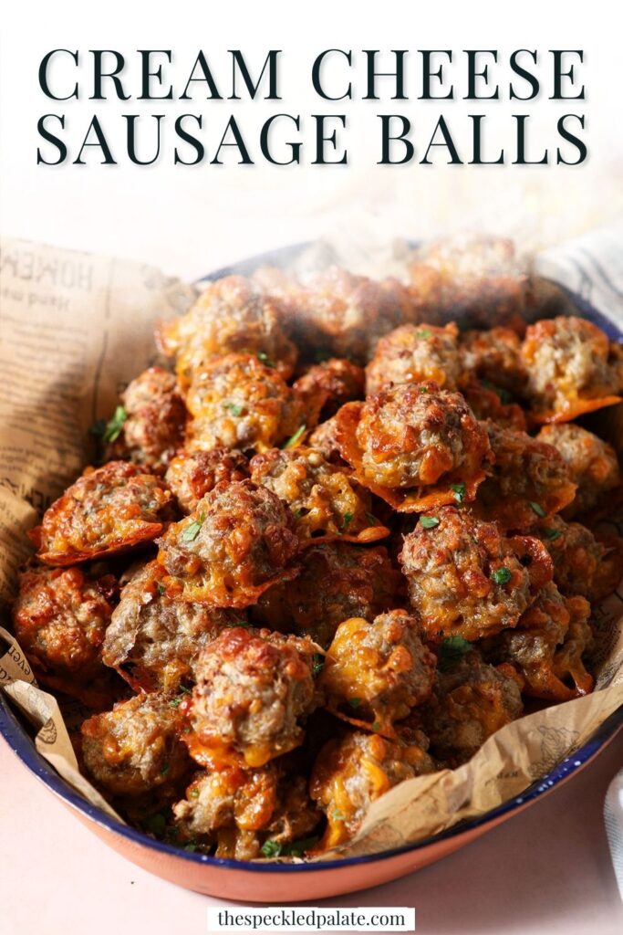 Close up of a sausage balls recipe garnished with chopped parsley with the text cream cheese sausage balls