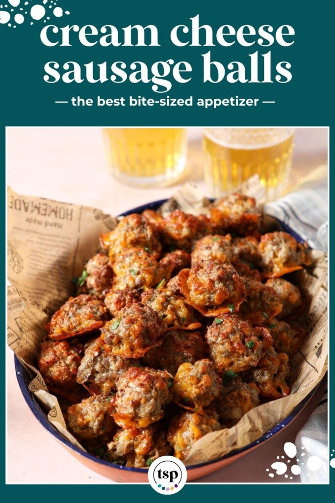 A platter of sausage balls without bisquick on a stone surface in front of two glasses of beer with the text cream cheese sausage balls the best bite-sized appetizer