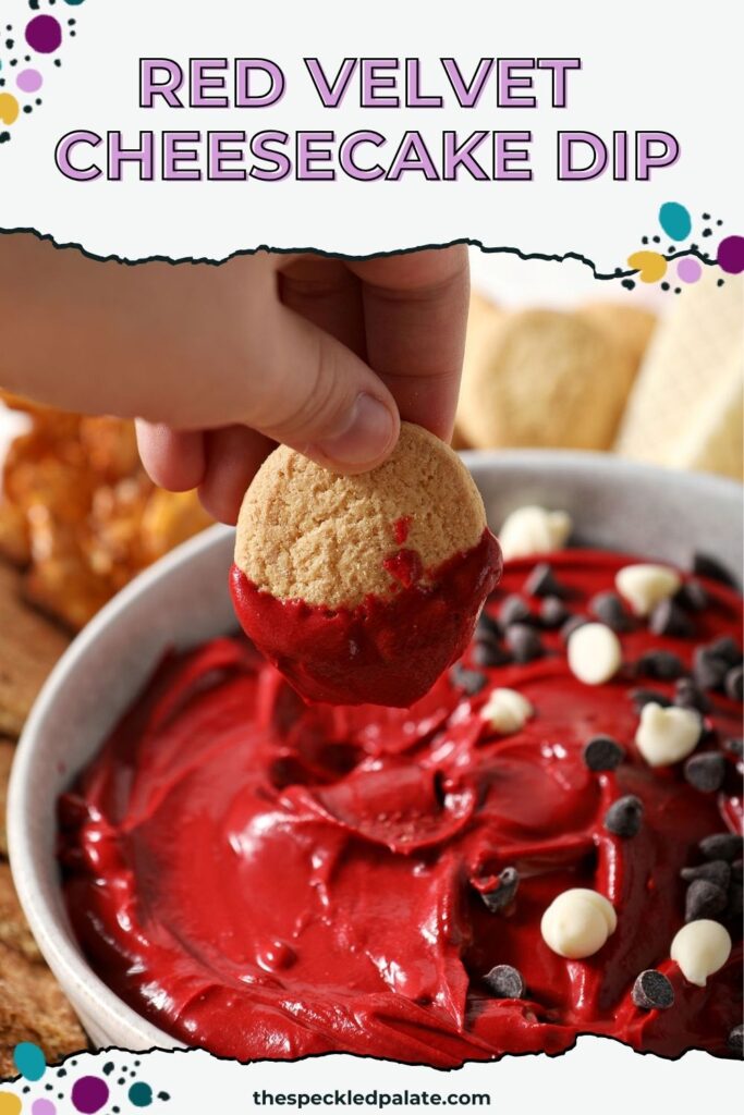 A hand dips a vanilla wafer cookie into red velvet dip with the text red velvet cheesecake dip
