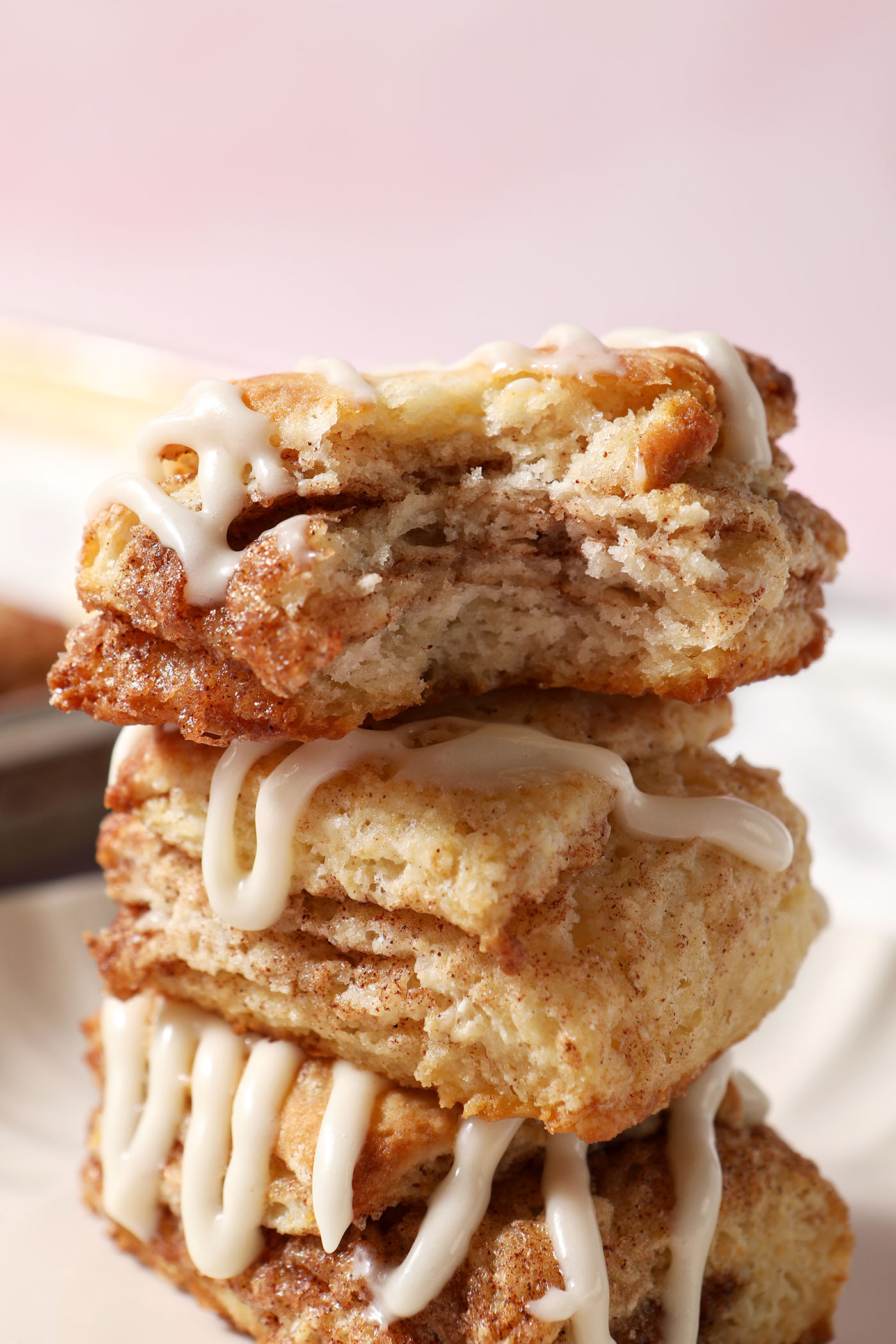 Closeup of a bitten-into cinnamon sugar biscuit on top of other biscuits