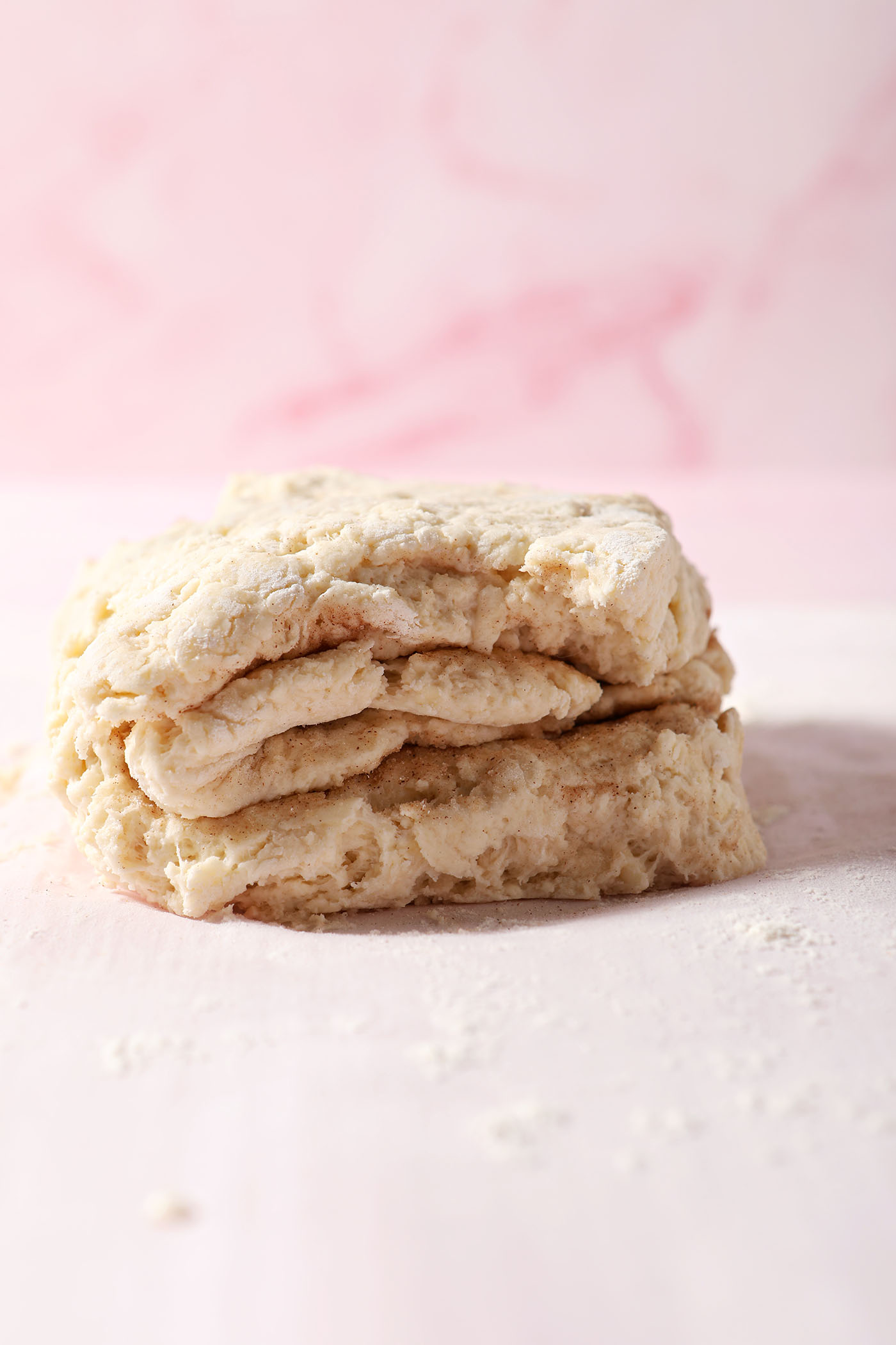 Layered biscuit dough on a floured surface